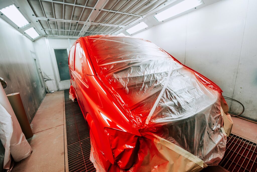 Red van being paint in special paint booth, Car painting details
